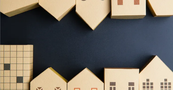 Cardboard boxes shaped like houses on a black background