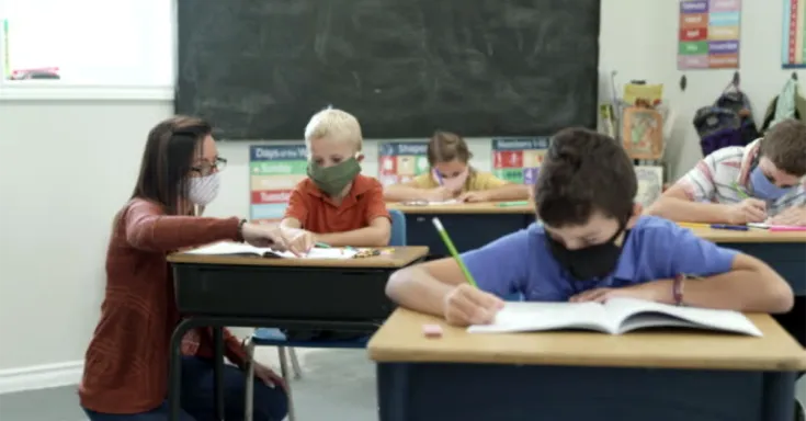 Education assistant helps student