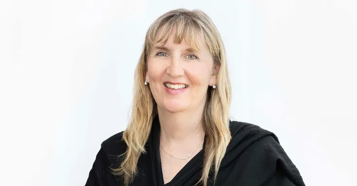 smiling woman in black shawl